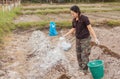 Woman gardeners put lime or calcium hydroxide into the soil to neutralize the acidity of the soil Royalty Free Stock Photo