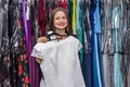 Woman in garment store trying on beautiful dress Royalty Free Stock Photo