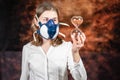 Woman in a gas mask holding a large glass sand timer . Coronovirus Quarantine, Stay Home Concept. Covid-19 pandemic Royalty Free Stock Photo