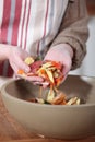 Woman gathering vegetable peelings Royalty Free Stock Photo