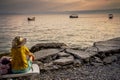 Woman gazes across lake Ohrid at sunset