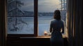 a woman gazing out of a window at a snow-covered outdoor scene, the coziness of an indoor space and the contrast with