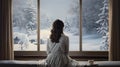 a woman gazing out of a window at a snow-covered outdoor scene, the coziness of an indoor space and the contrast with