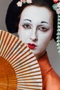 Woman in geisha makeup and a traditional Japanese kimono. Studio, Indoor. Royalty Free Stock Photo