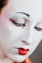 Woman in geisha makeup and a traditional Japanese kimono. Studio, Indoor. Royalty Free Stock Photo