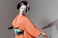 Woman In Geisha Makeup And A Traditional Japanese Kimono. Studio, Indoor.