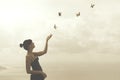 Woman gently touches free flying butterflies