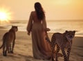 woman and gepard on sand wild desert at sunset animal world nature landscape Royalty Free Stock Photo