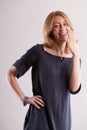 Woman gestures, teasingly hides her laughter Royalty Free Stock Photo