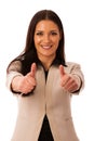 Woman gesturing success with thumbs up and big happy smile. Royalty Free Stock Photo