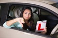 Woman gesturing thumbs down holding a learner driver sign Royalty Free Stock Photo