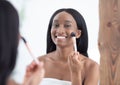 Woman get ready for work, does morning routine nude makeup, putting blush in bathroom at home Royalty Free Stock Photo