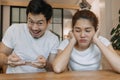 Woman gets bored boyfriend addicted mobile game on their date. Asian couple