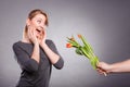 Woman gets bouquet of tulips from man.