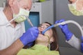 Woman gets dental treatment from senior dentist Royalty Free Stock Photo