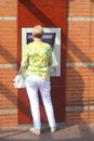 Woman gets money from an ATM, Netherlands