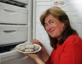 Woman gets out of refrigerator frozen meatba