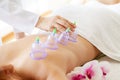 Woman getting anti-cellulite massage of back with use of vacuum cans in beauty studio Royalty Free Stock Photo
