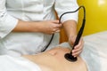 Woman getting anti cellulite therapy in beauty salon. RF lifting Royalty Free Stock Photo