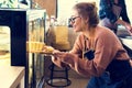 Woman getting cake out of the display fridge Royalty Free Stock Photo