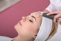 Woman getting cleansing rejuvenating facial treatment in a beauty SPA salon