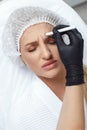 Woman getting cosmetic injection of botox in cheek, closeup. Royalty Free Stock Photo