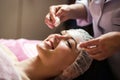 woman getting facial care peeling mask by beautician at spa salon Royalty Free Stock Photo