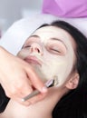 Woman getting a facial with cream Royalty Free Stock Photo