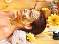 Woman getting facial mask .