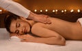 Woman getting healing body massage session at newest spa
