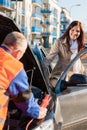 Woman getting into her car mechanic fixing Royalty Free Stock Photo