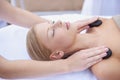 Woman getting hot stone massage, hands of masseuse in spa and healing holistic treatment with zen at wellness resort Royalty Free Stock Photo