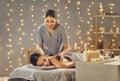 Young girl lying on spa table, relaxing and enjoying spa massage with hot stones Royalty Free Stock Photo