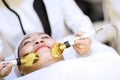 Woman getting laser and ultrasound face treatment in medical spa center. skin rejuvenation concept. woman laying eyes closed, rece Royalty Free Stock Photo