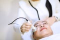 Woman getting laser and ultrasound face treatment in medical spa center. skin rejuvenation concept. woman laying eyes closed, rece Royalty Free Stock Photo