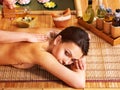 Woman getting massage in bamboo spa. Royalty Free Stock Photo