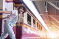 Woman getting off the train at train station with copy space. Beautiful woman smiling get in subway for traveling Royalty Free Stock Photo