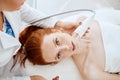 Woman getting rf-lifting in a beauty salon. Modern technologies in cosmetology.