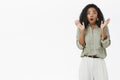 Woman getting shocked being scared of sudden noise. Stunned stylish attractive adult businesswoman in trendy shirt and