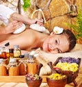 Woman getting thai herbal compress massage . Royalty Free Stock Photo