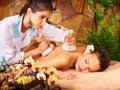 Woman getting thai herbal compress massage .