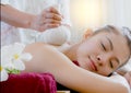 woman getting thai herbal compress massage Royalty Free Stock Photo