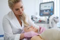 Woman getting treatment with aesthetic dermatology device Royalty Free Stock Photo