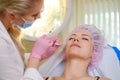 Woman getting treatment with injectable hyaluronic acid dermal filler