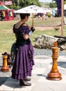 A woman and a giant chess pieces at Renaissance Festival