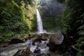 Woman at the giant Nungnung waterfall on Bali island, Indonesia Royalty Free Stock Photo