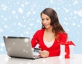 Woman with gift, laptop computer and credit card Royalty Free Stock Photo