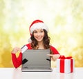 Woman with gift, laptop computer and credit card Royalty Free Stock Photo