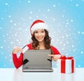 Woman with gift, laptop computer and credit card Royalty Free Stock Photo