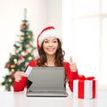 Woman with gift, laptop computer and credit card Royalty Free Stock Photo